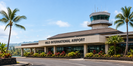 Hilo International Airport entrance beneath bright blue tropical skies